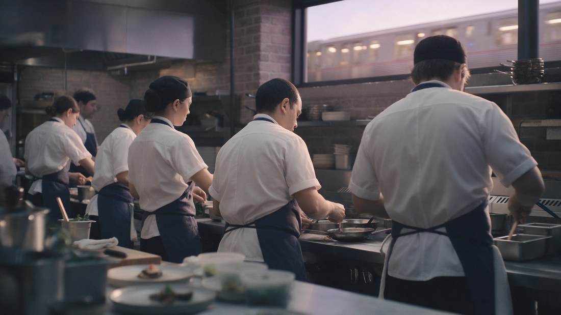 A line of cooks in a Chicago restaurant kitchen
